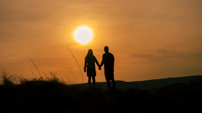 Couple at sunset on Persaudaraan Hill, East Sumba