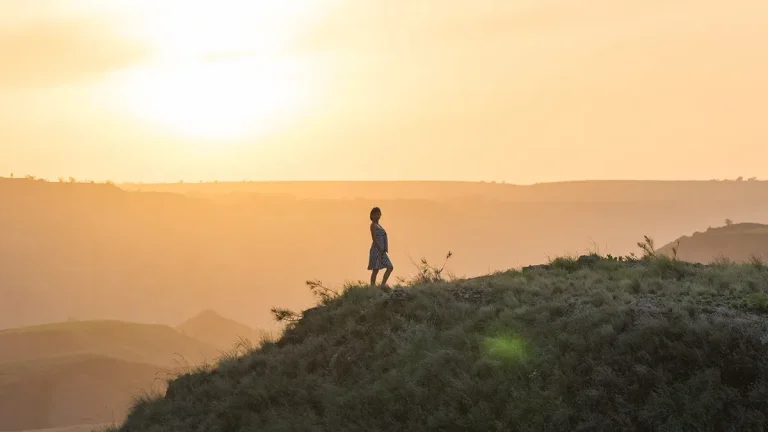 Lone traveller on Wairinding Hill at dawn, East Sumba